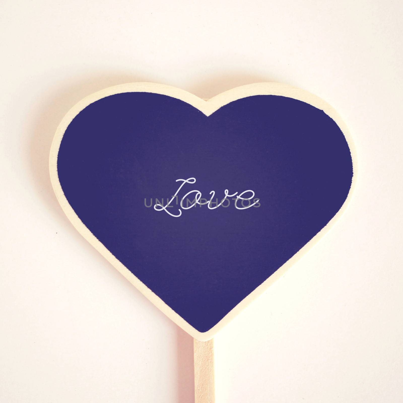 Love word on heart shaped blackboard, retro filter effect 