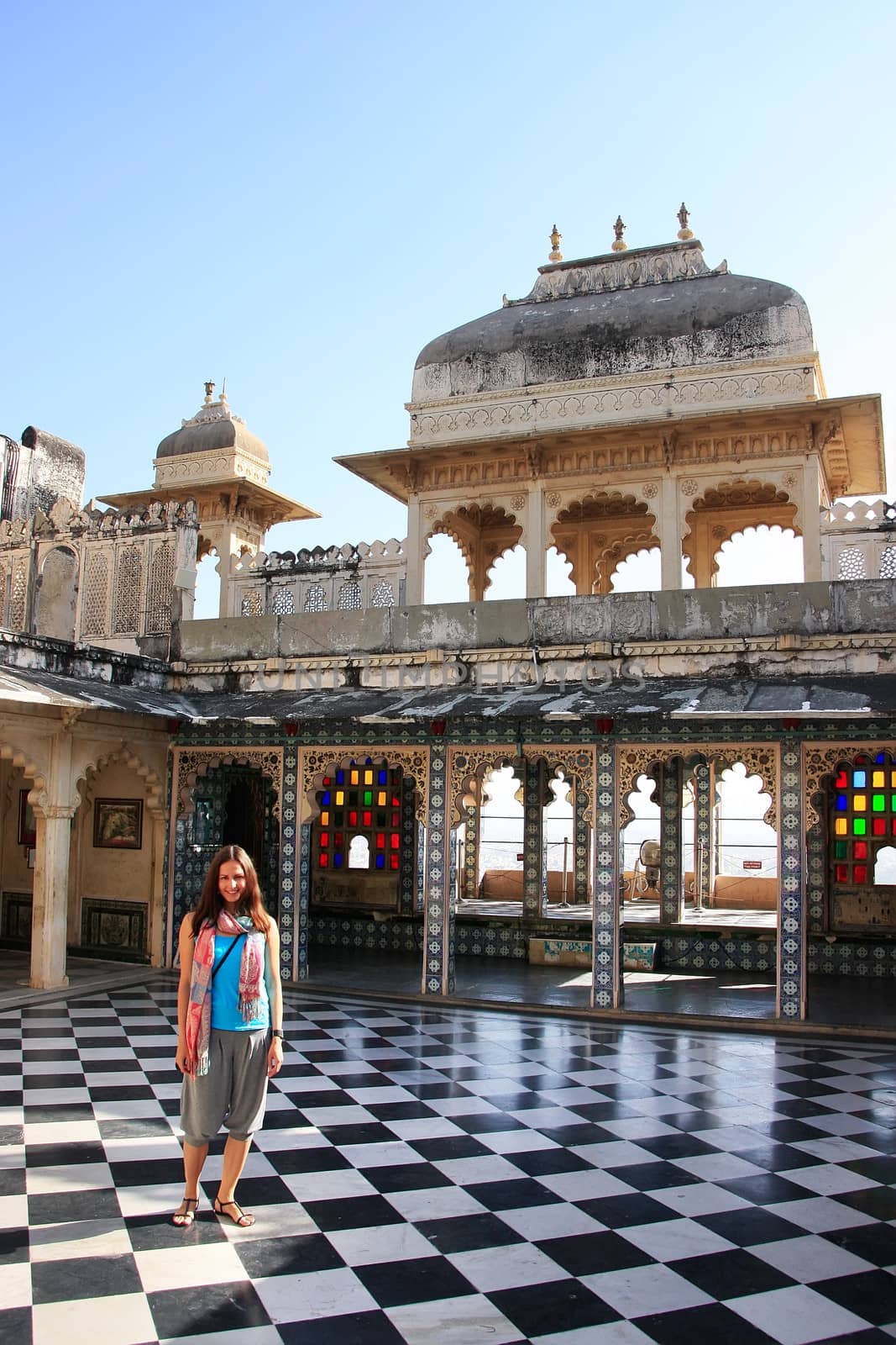 Young woman standing at Peacock Square, City Palace complex, Udaipur, Rajasthan, India