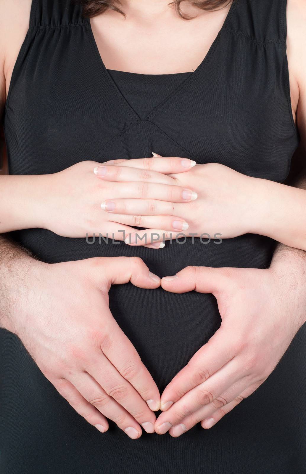 Shape of heart from fingers on pregnant tummy