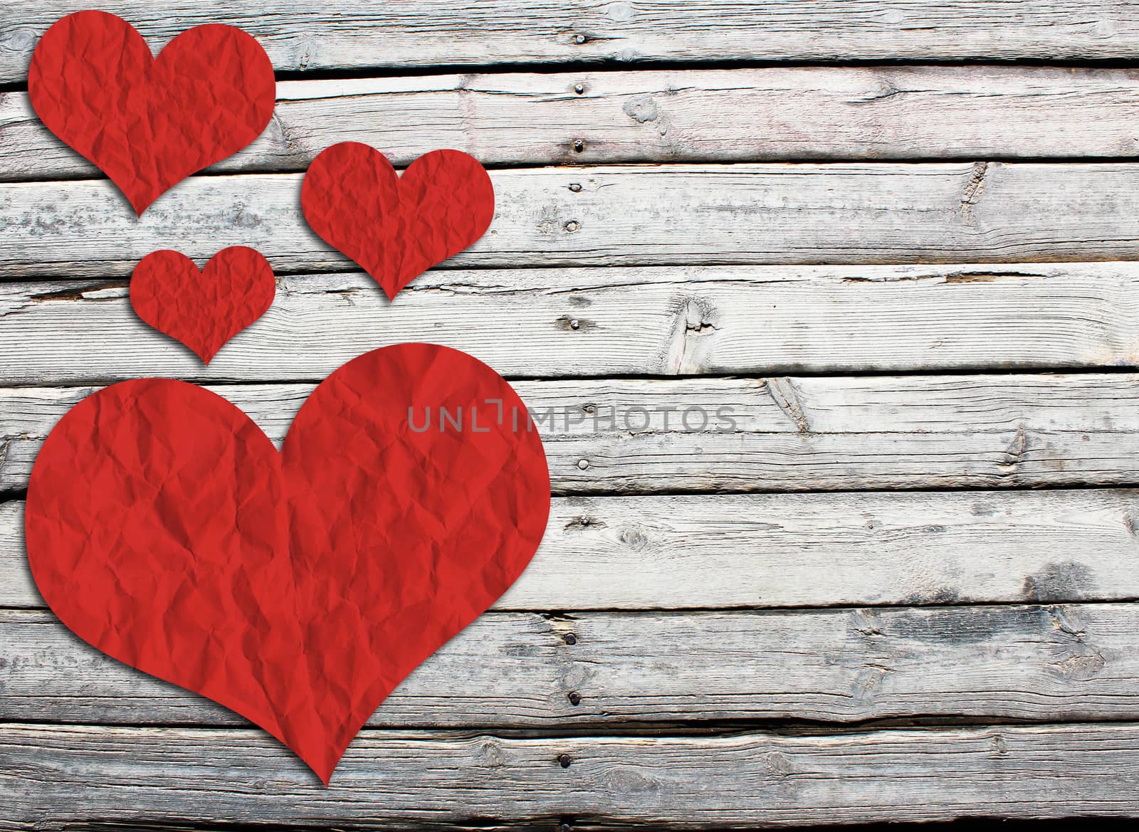 Paper hearts on a wooden surface by cherezoff