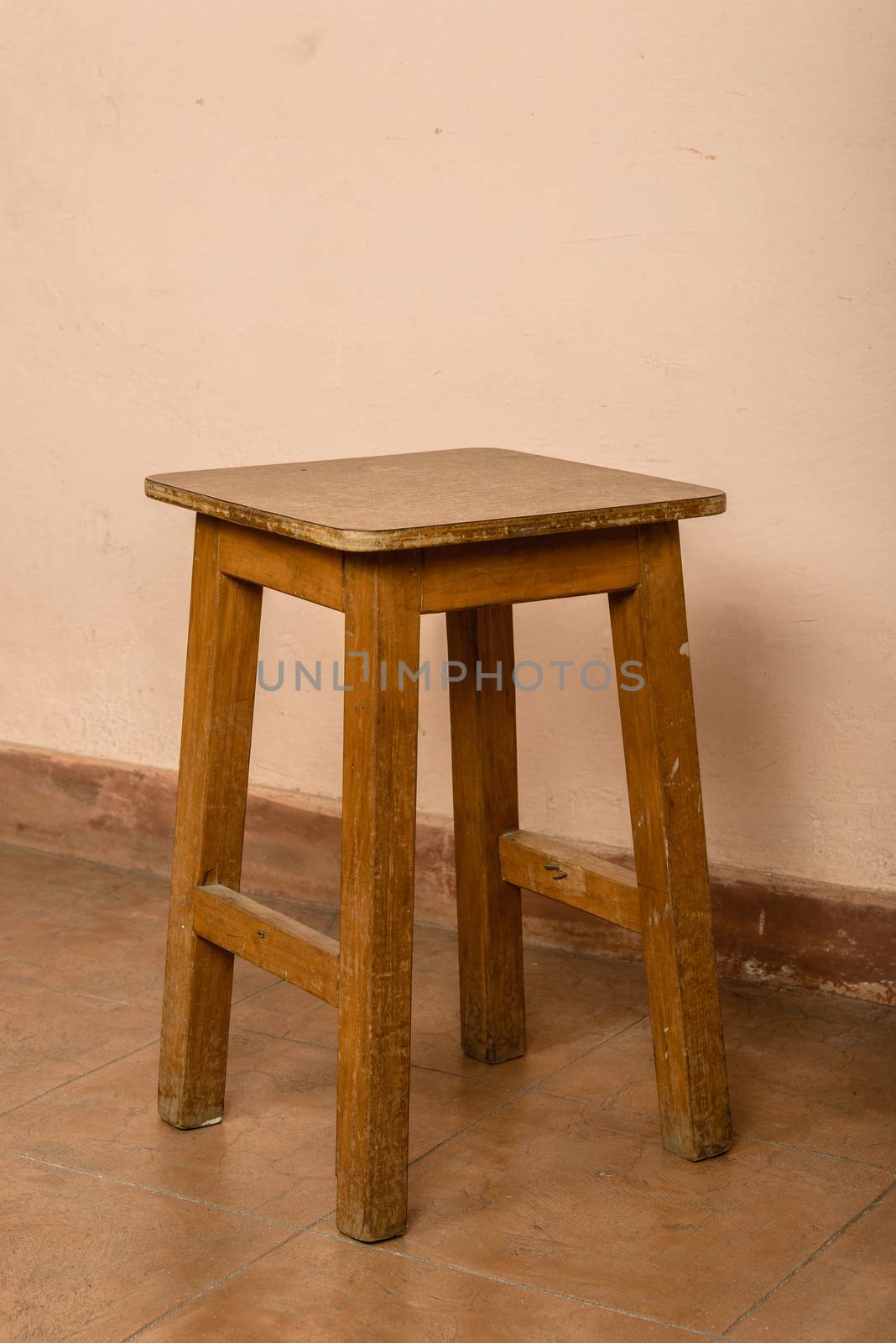 Rustic wood stool, pink wall background