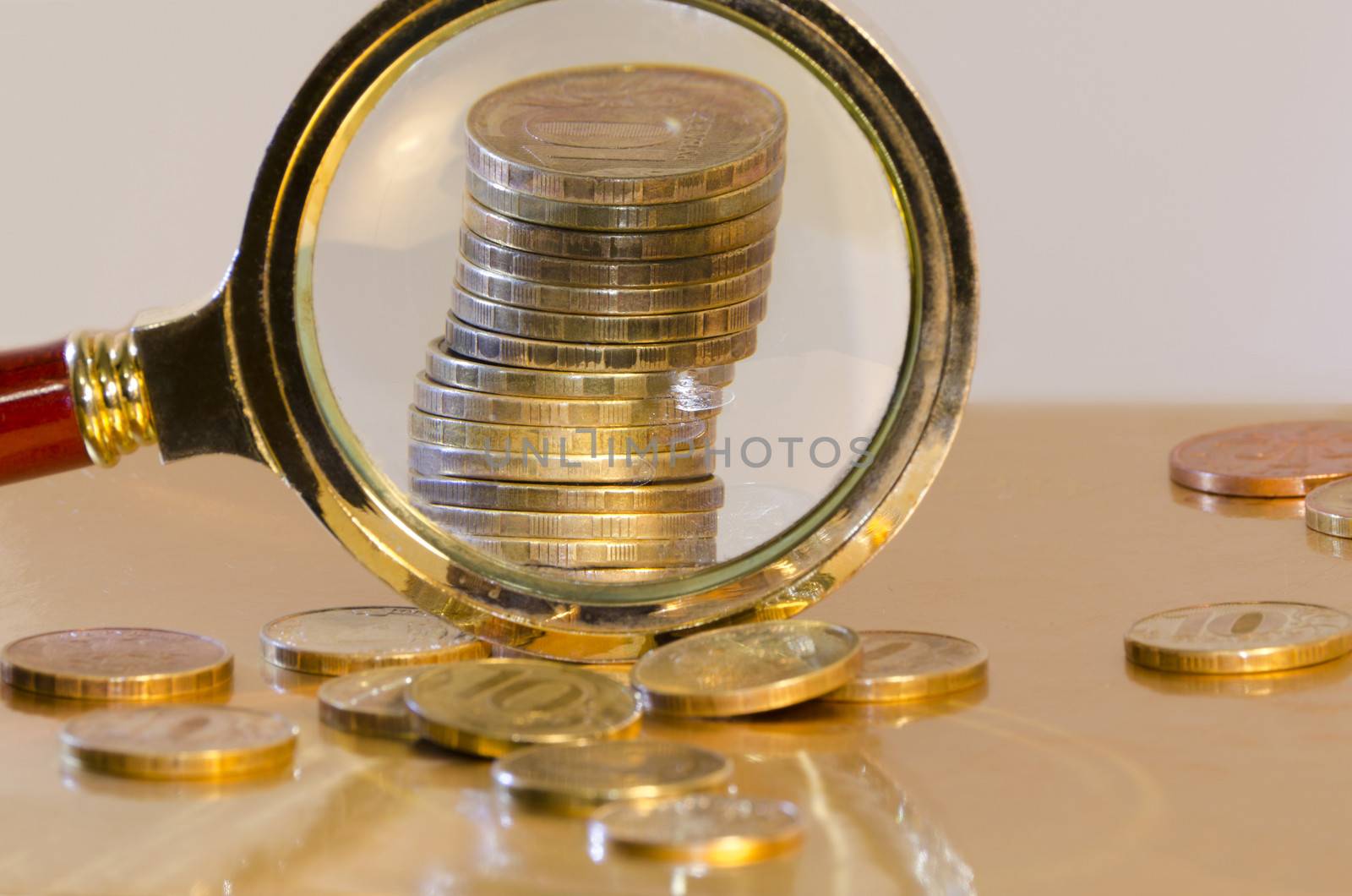 A stack of coins, increased under a magnifying glass