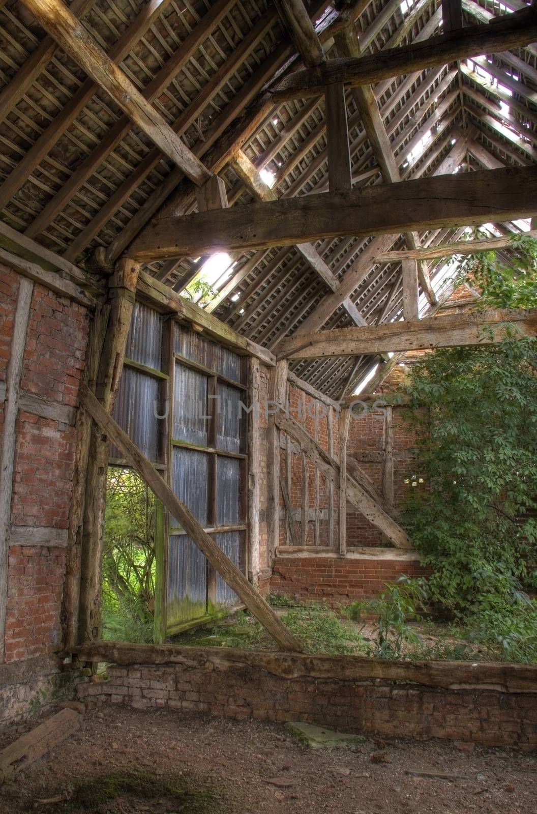 Timber-frame and brick constructed English barn interior.