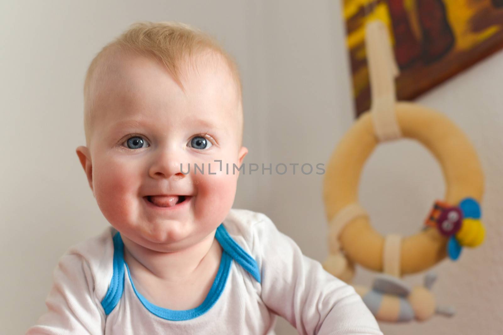 Portrait of a six month old baby boy looking curious at the camera