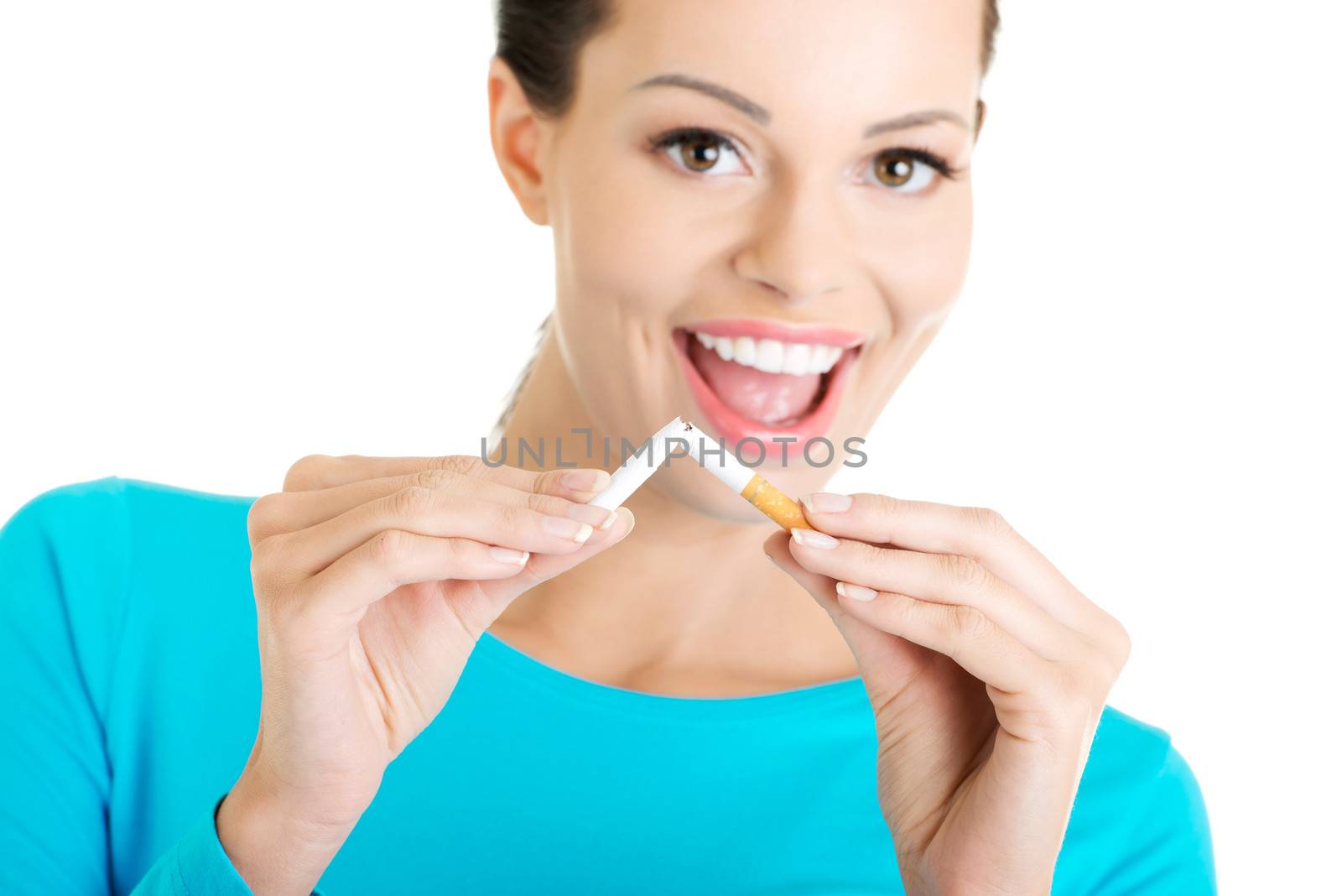 Young happy woman with broken cigarette. Stop smoking concept.