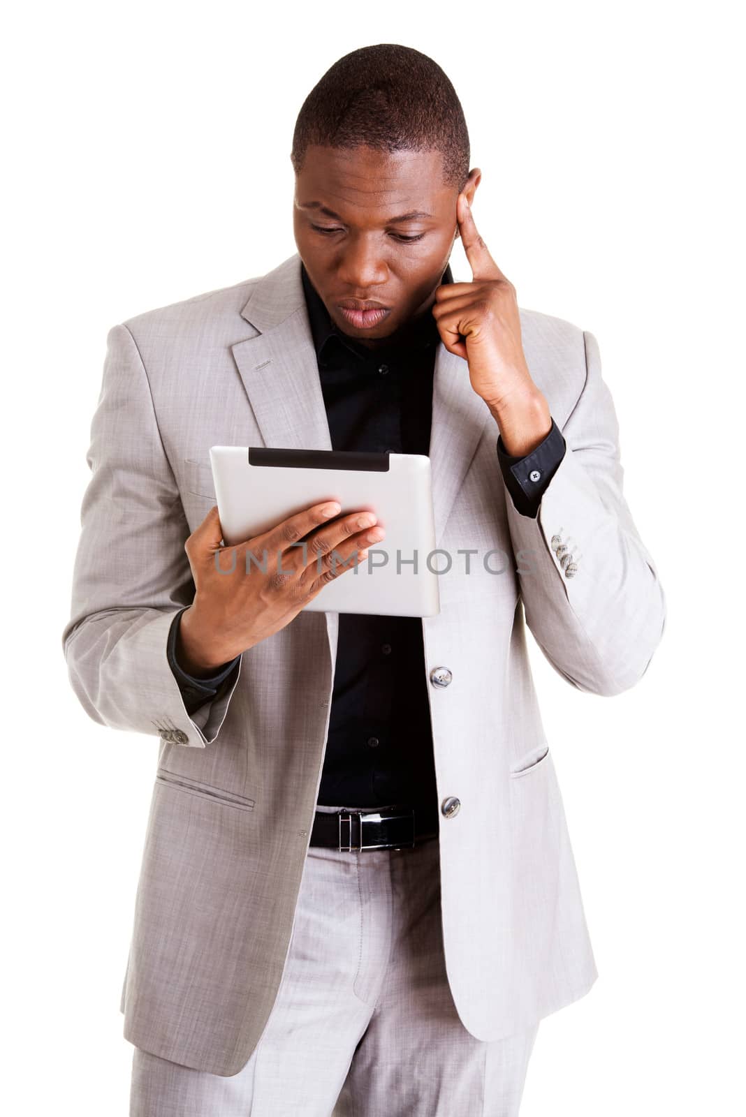 Handsome businessman working on tablet computer. Isolated on white.