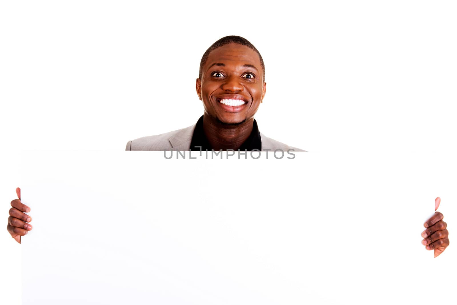 Happy successful businessman holding and showing blank advertisement. Isolated on white.