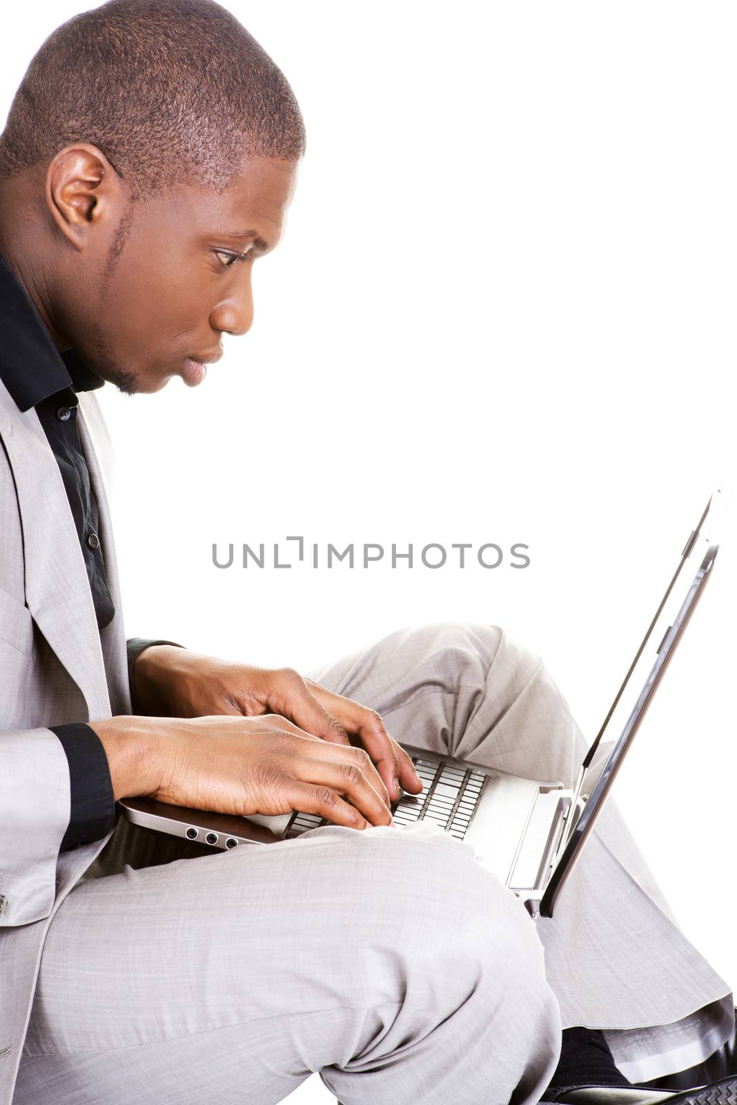 Successful businessman working on laptop, isolated on white