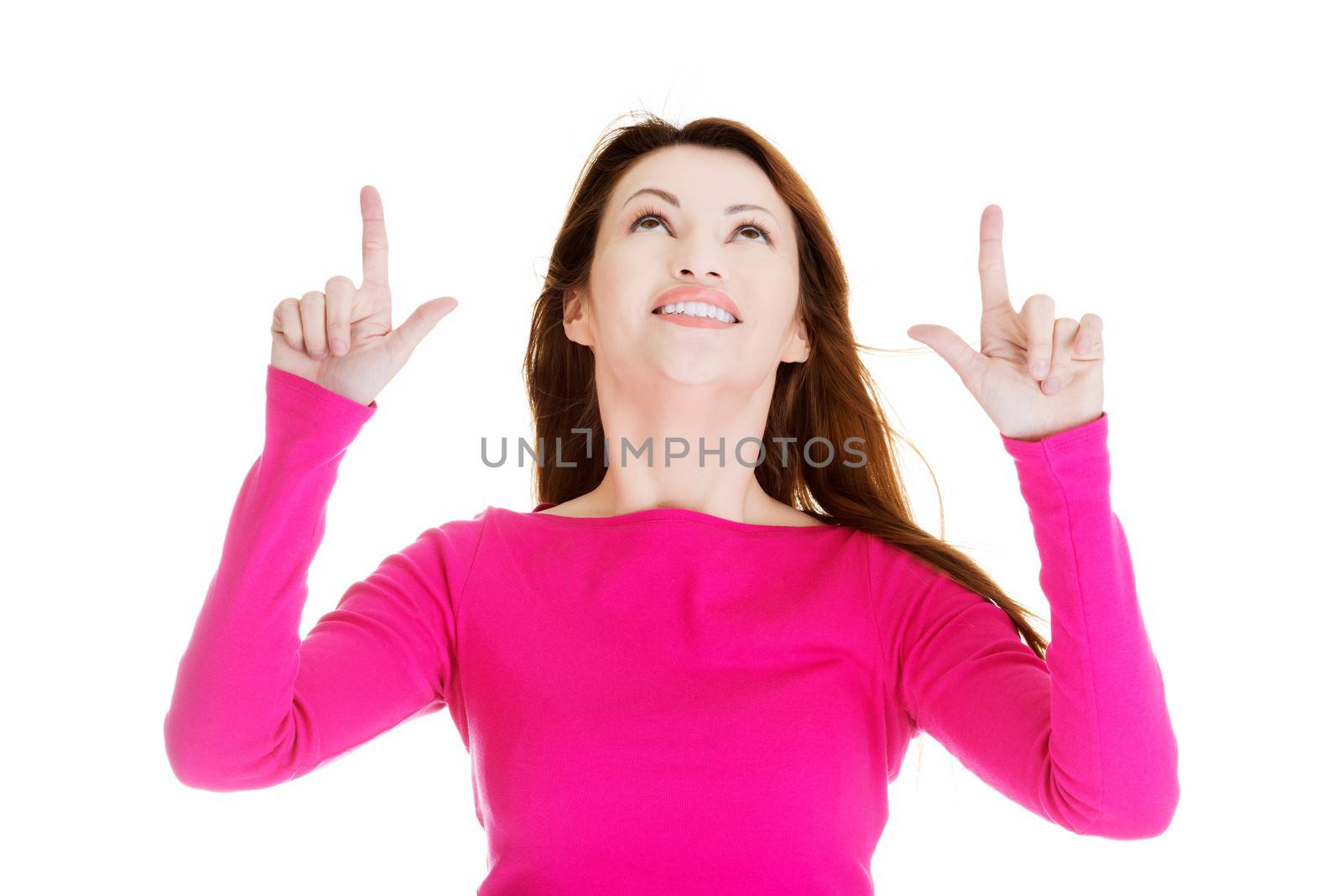 Happy , excited woman pointing on copy space, isolated on white