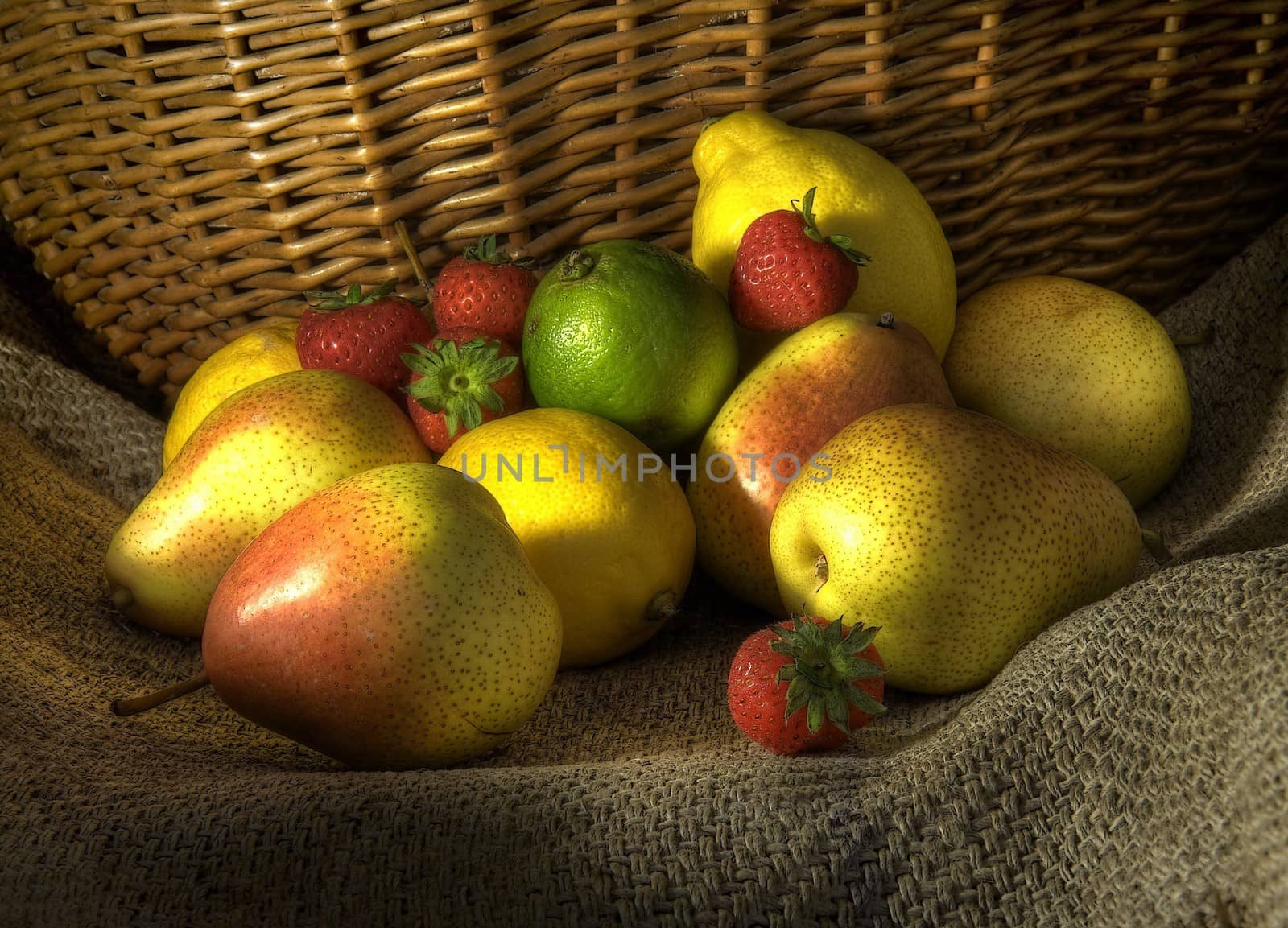 Fruit on hessian against a wicker basket.