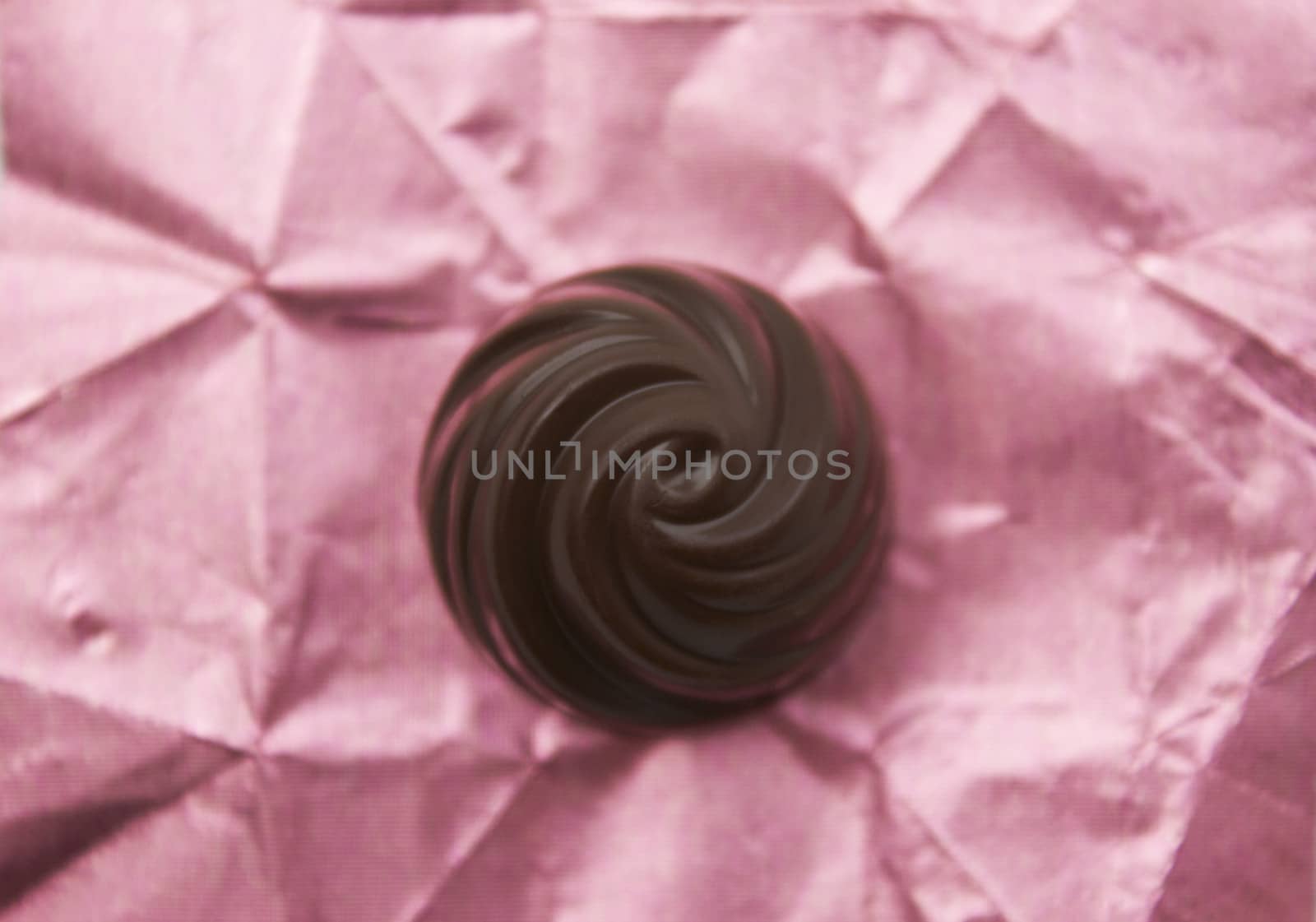 Chocolate candy on a pink wrapping.