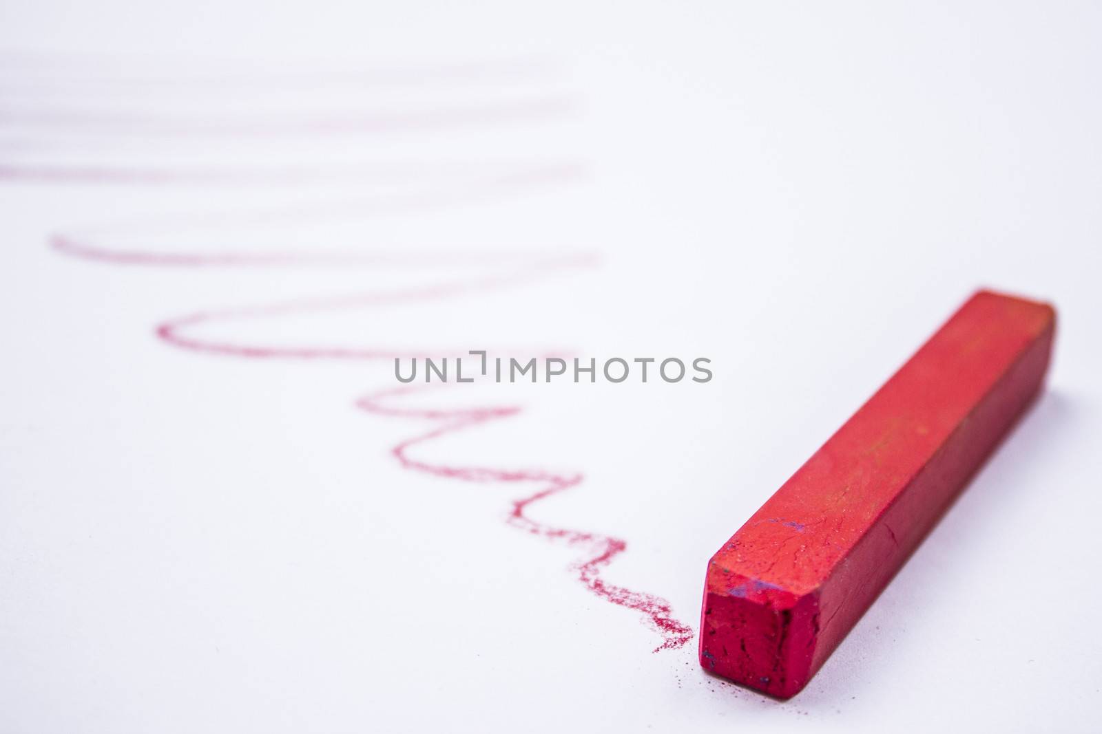 Pastels lying around on a white background.