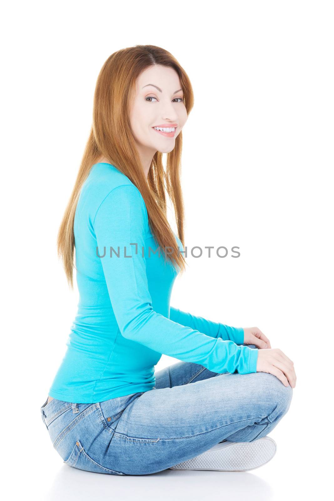 Happy attractive woman sitting, isolated on white