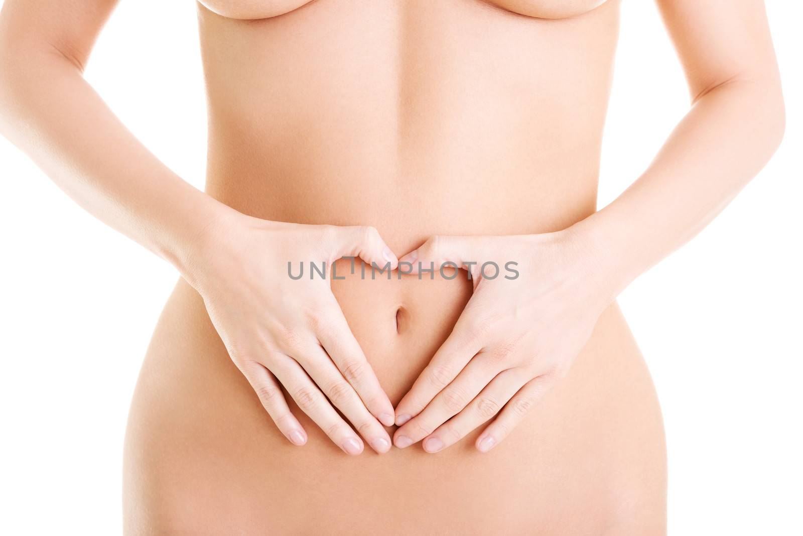 Attractive woman making heart shape on belly by BDS