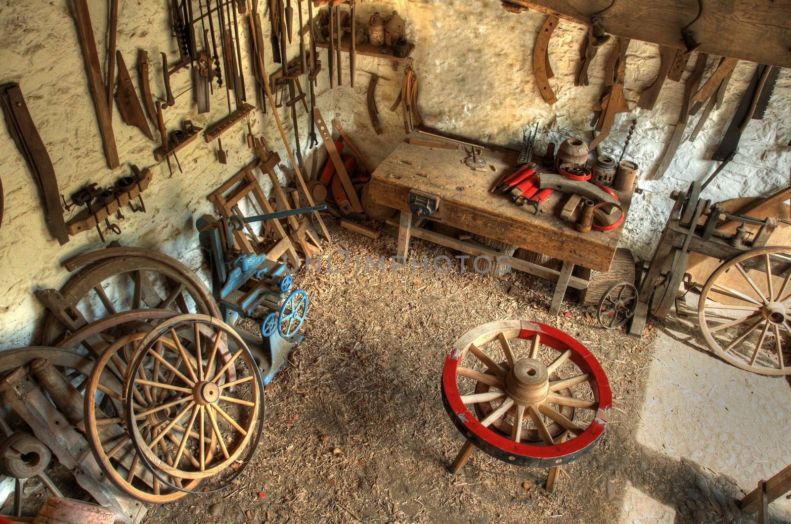 Traditional wheelwrights workshop with tools and cartwheels, England.