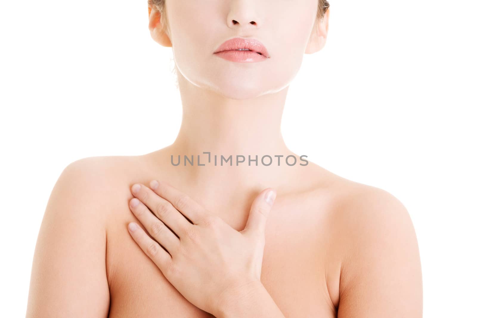 Beautiful sensual young woman touching her chest, isolated on white