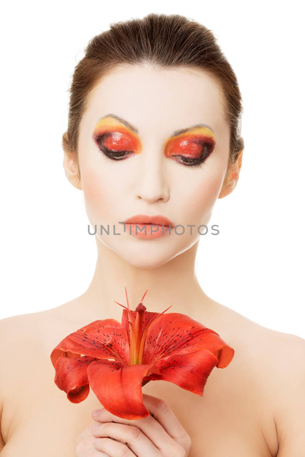 Beautiful woman with a red lily, isolated on white