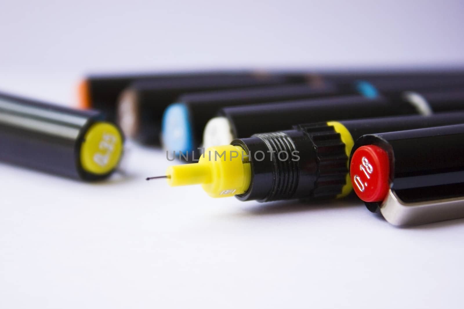 Technical pens on a white background.