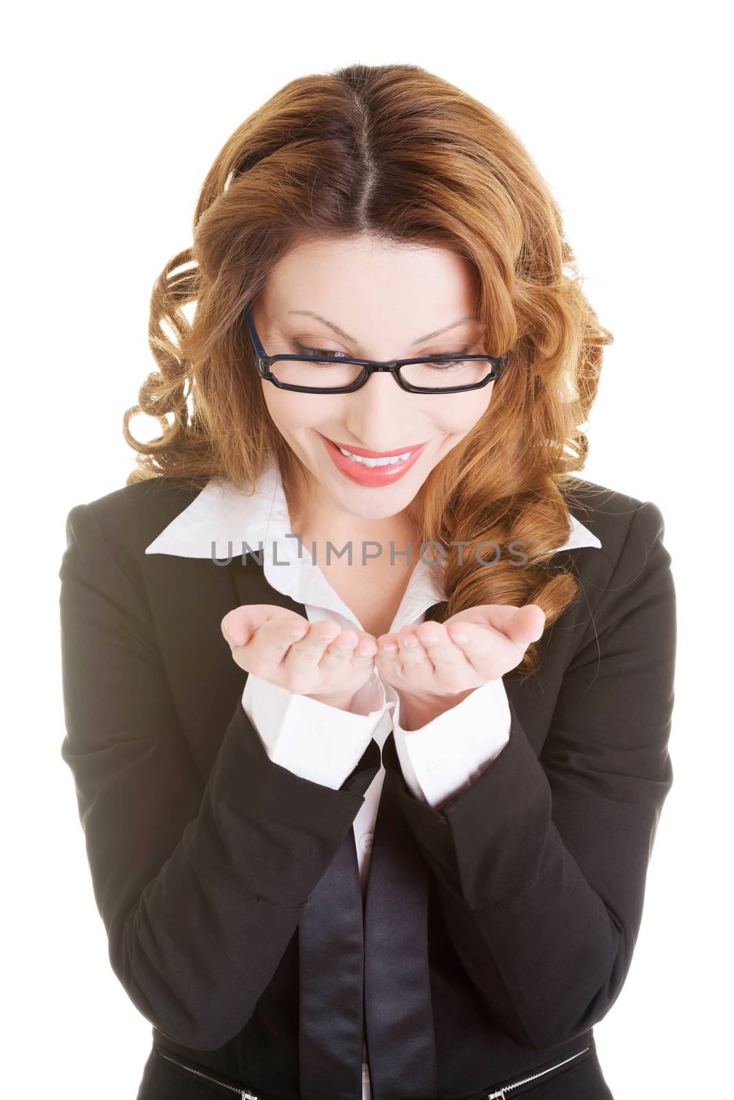 Happy business woman showing copy space on her palm, isolated on white