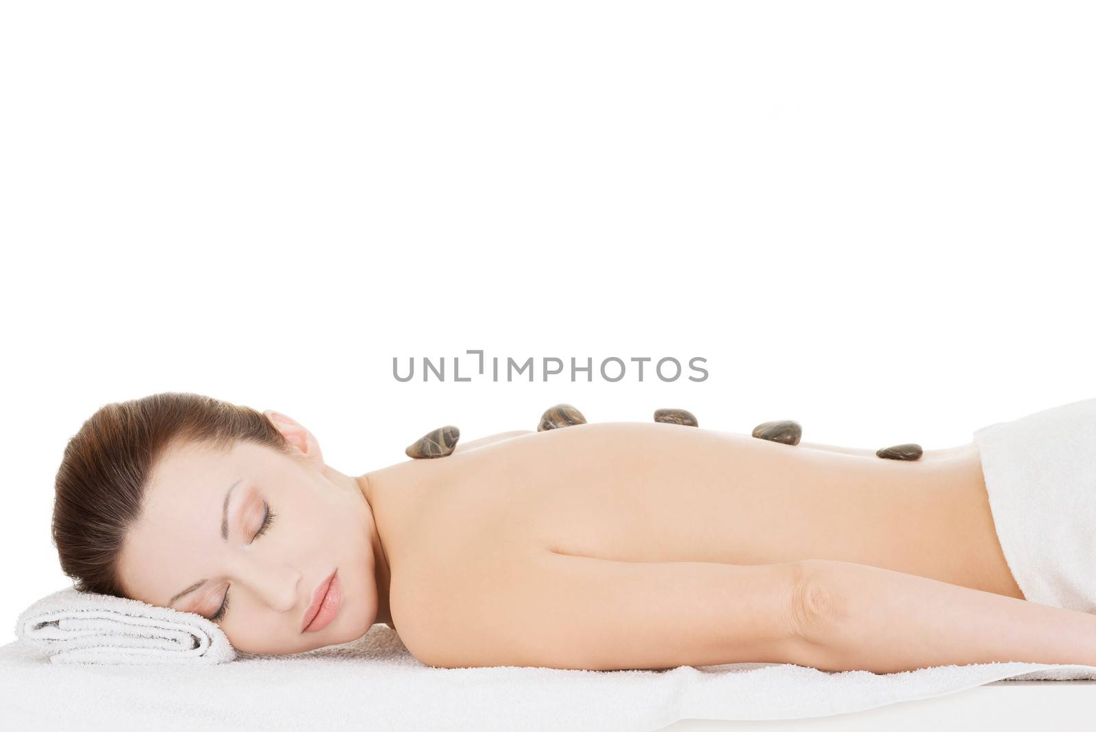 Beauty woman relaxing in spa. Stone massage.