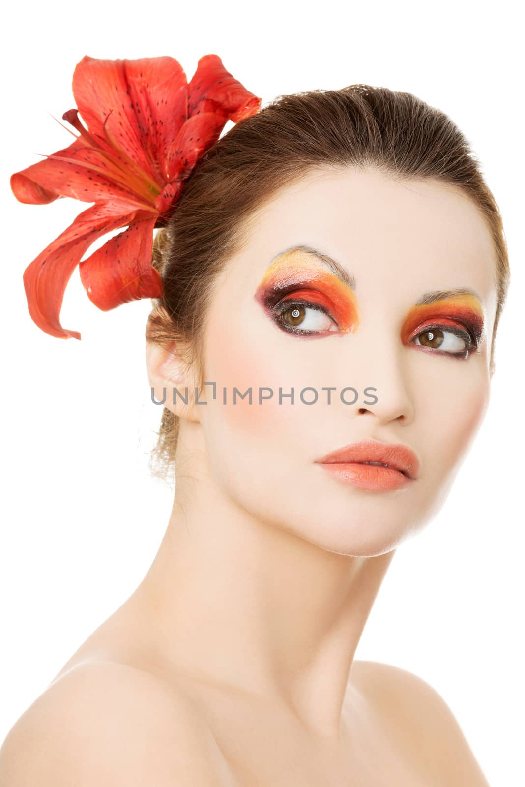 Beautiful woman with a red lily, isolated on white