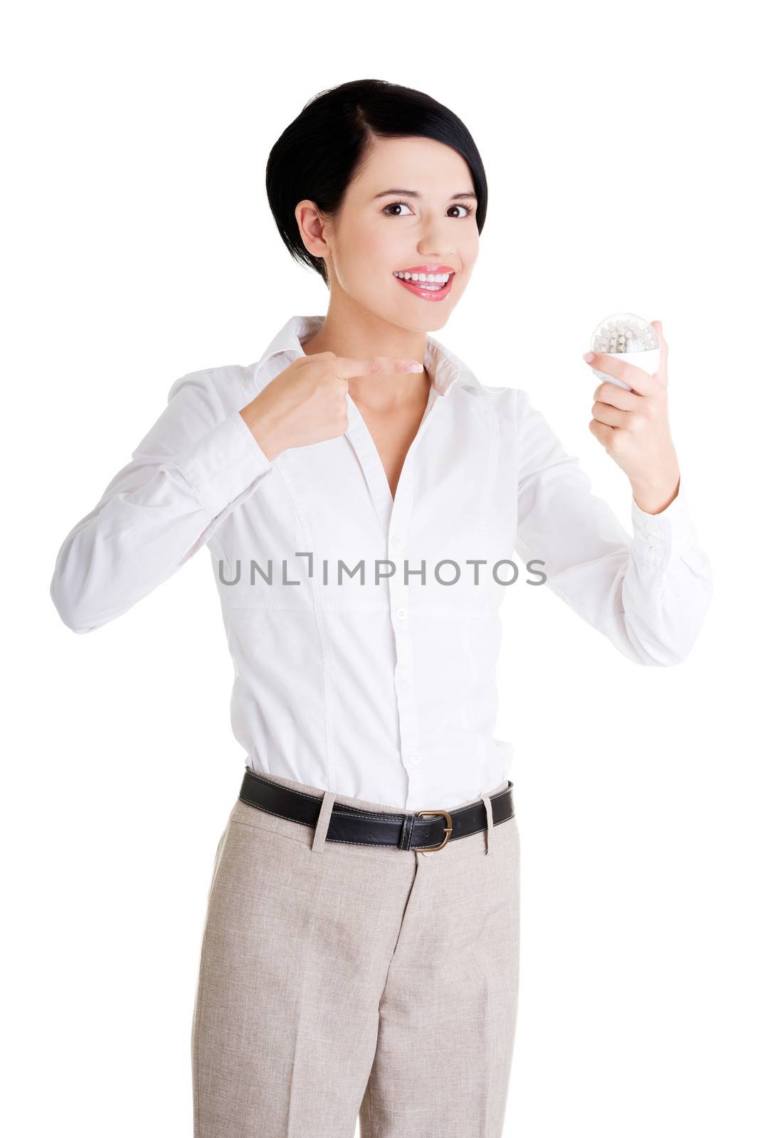 Businesswoman showing led bulb, isolated on white