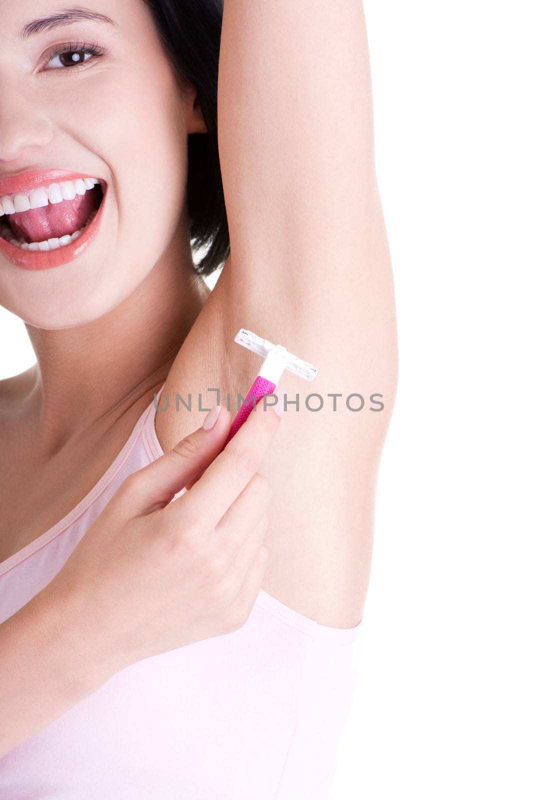 Beautiful smiling young woman shaving her armpit