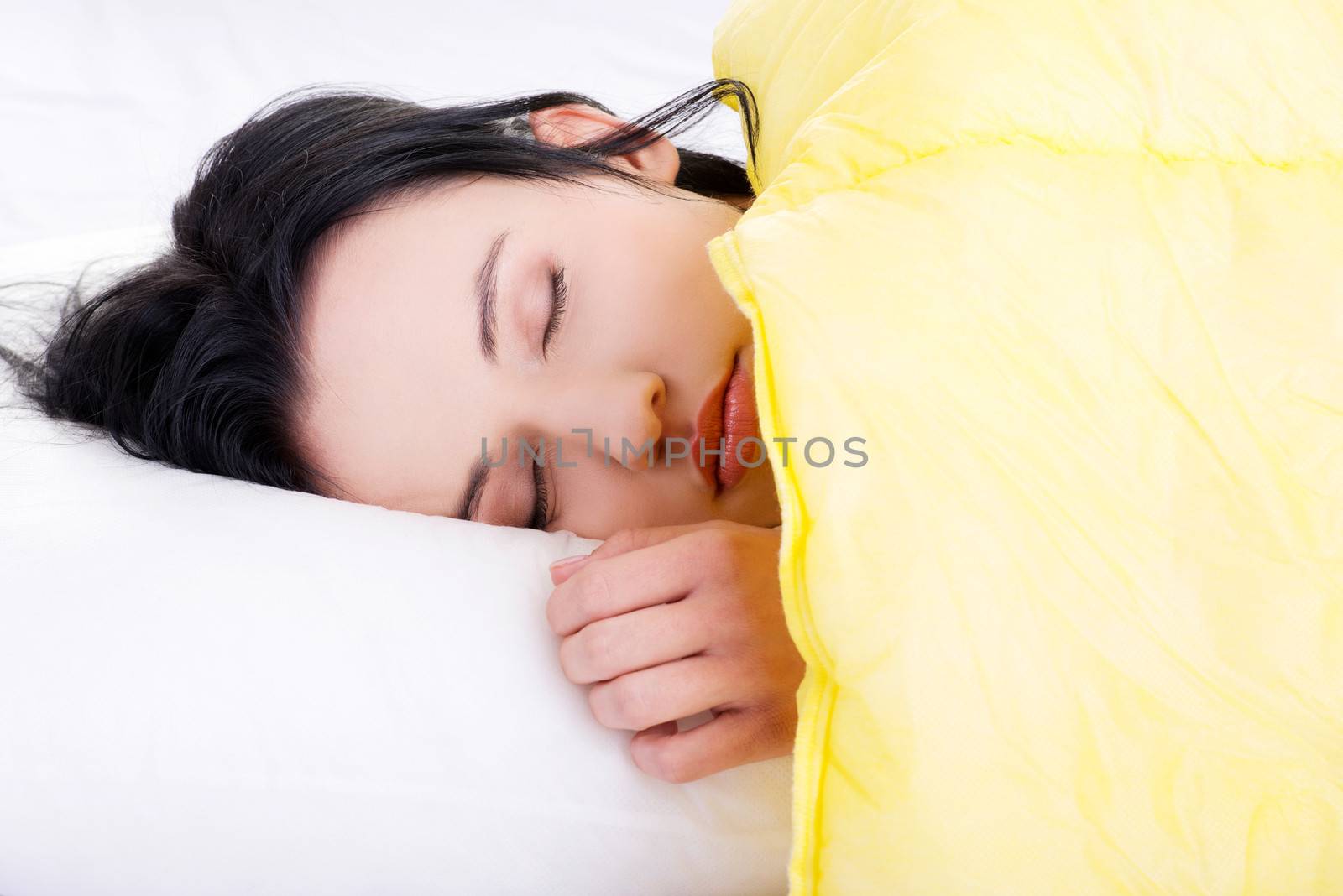 Beautiful happy young woman resting in bed