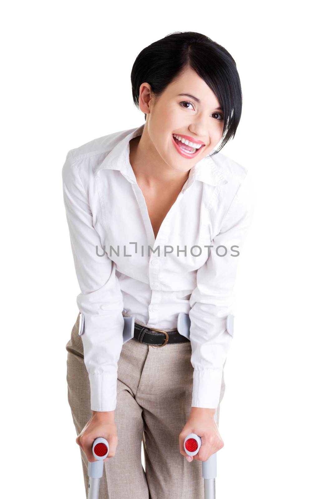 Happy young businesswoman with crutches, isolated on white. Disabled person in work.