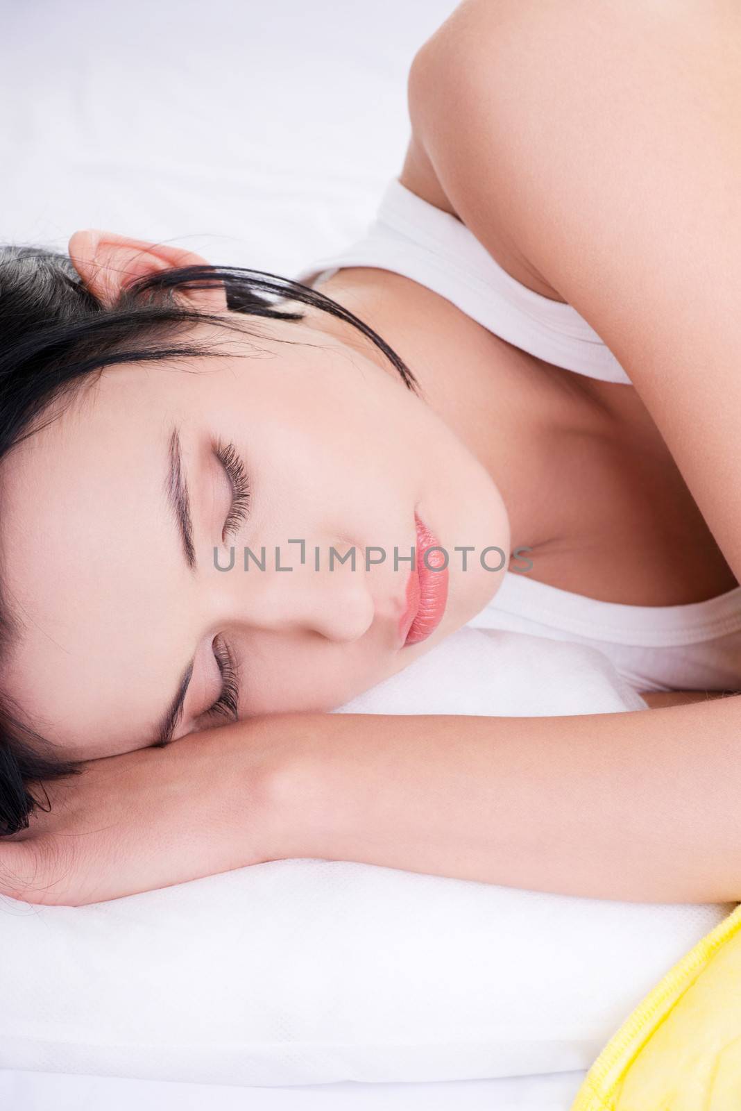 Beautiful happy young woman resting in bed