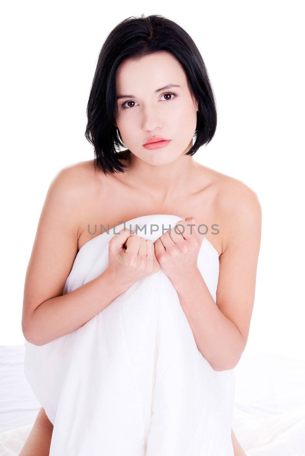 Sexy nude woman covering her body with sheet, isolated in white