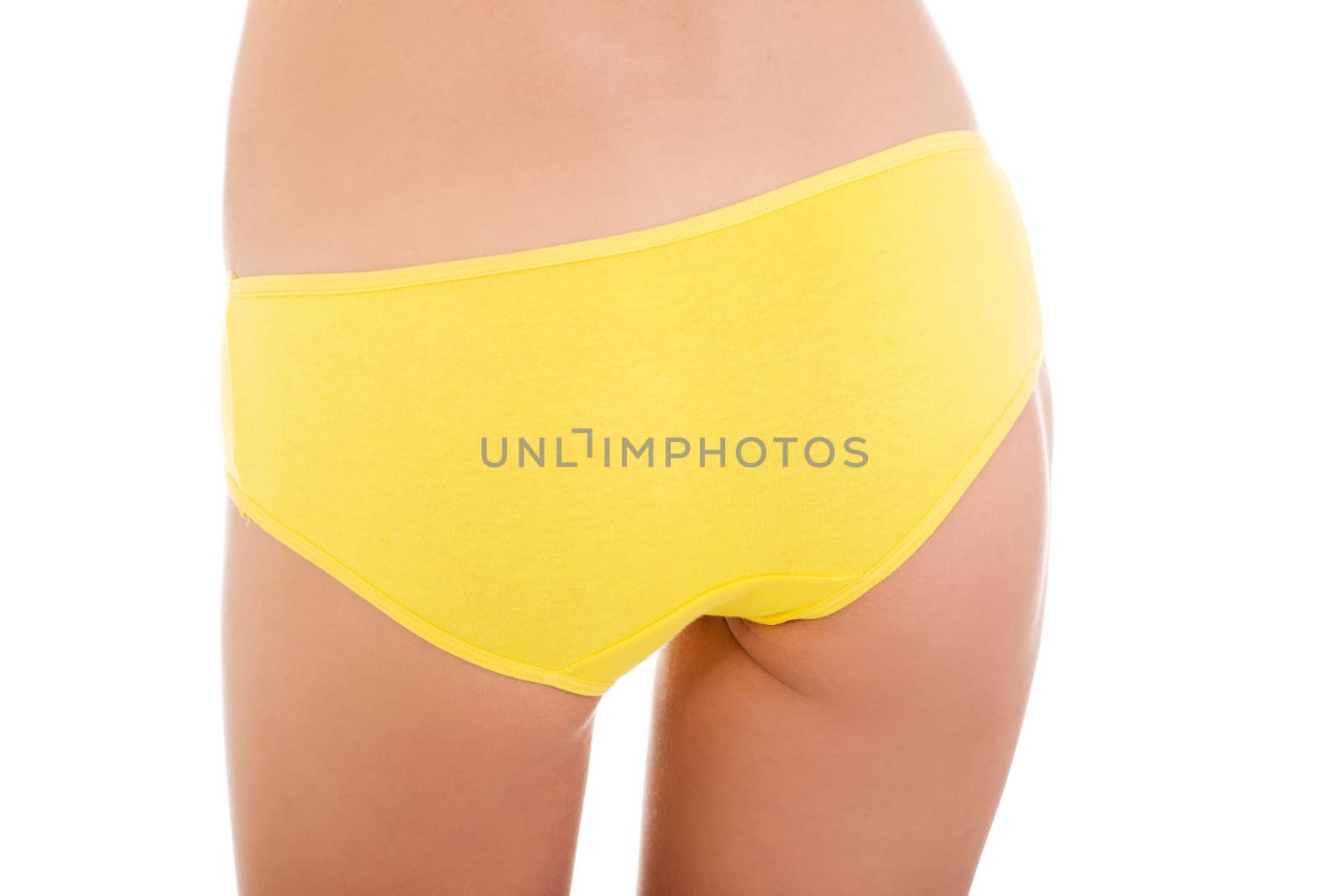 Slim tanned woman's body in yellow panties. Isolated over white background.