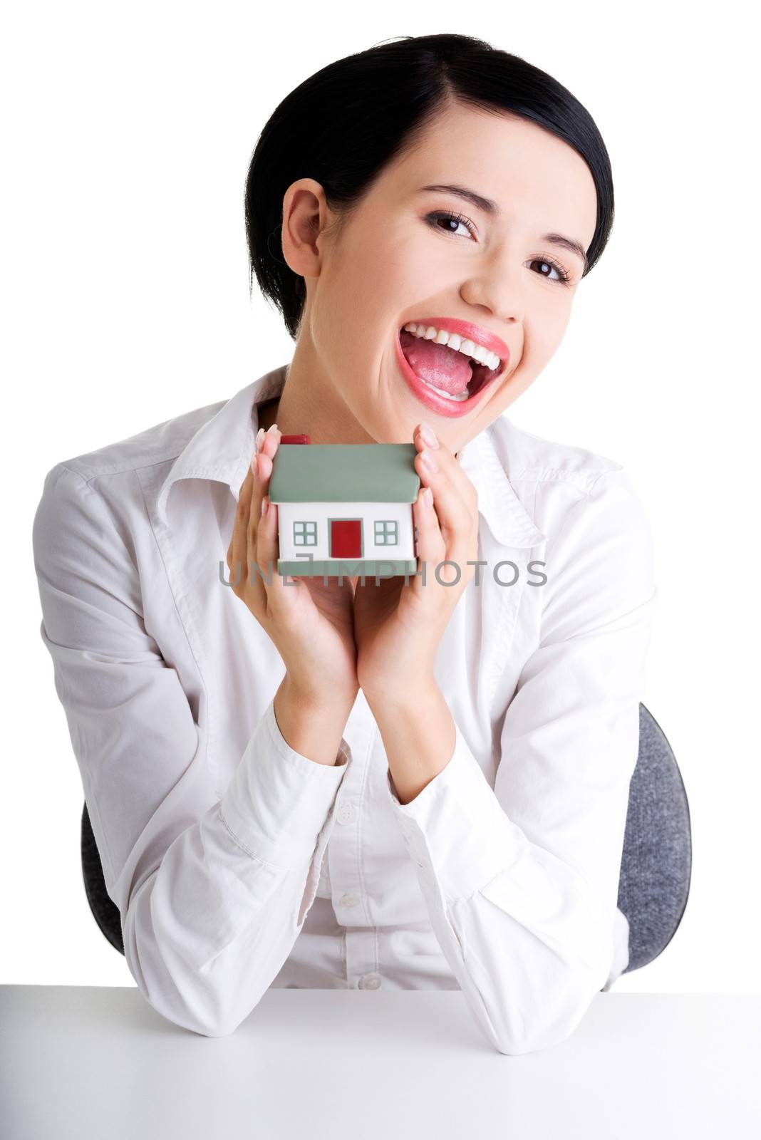 Female businesswoman hands holding and protecting house. Home protecting concept for insurance or security