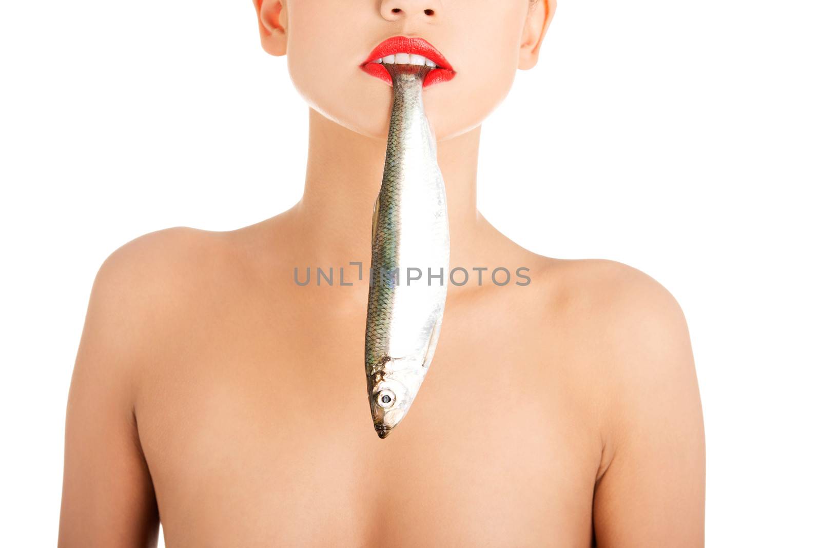 Beautiful young woman with fish in her mouth
