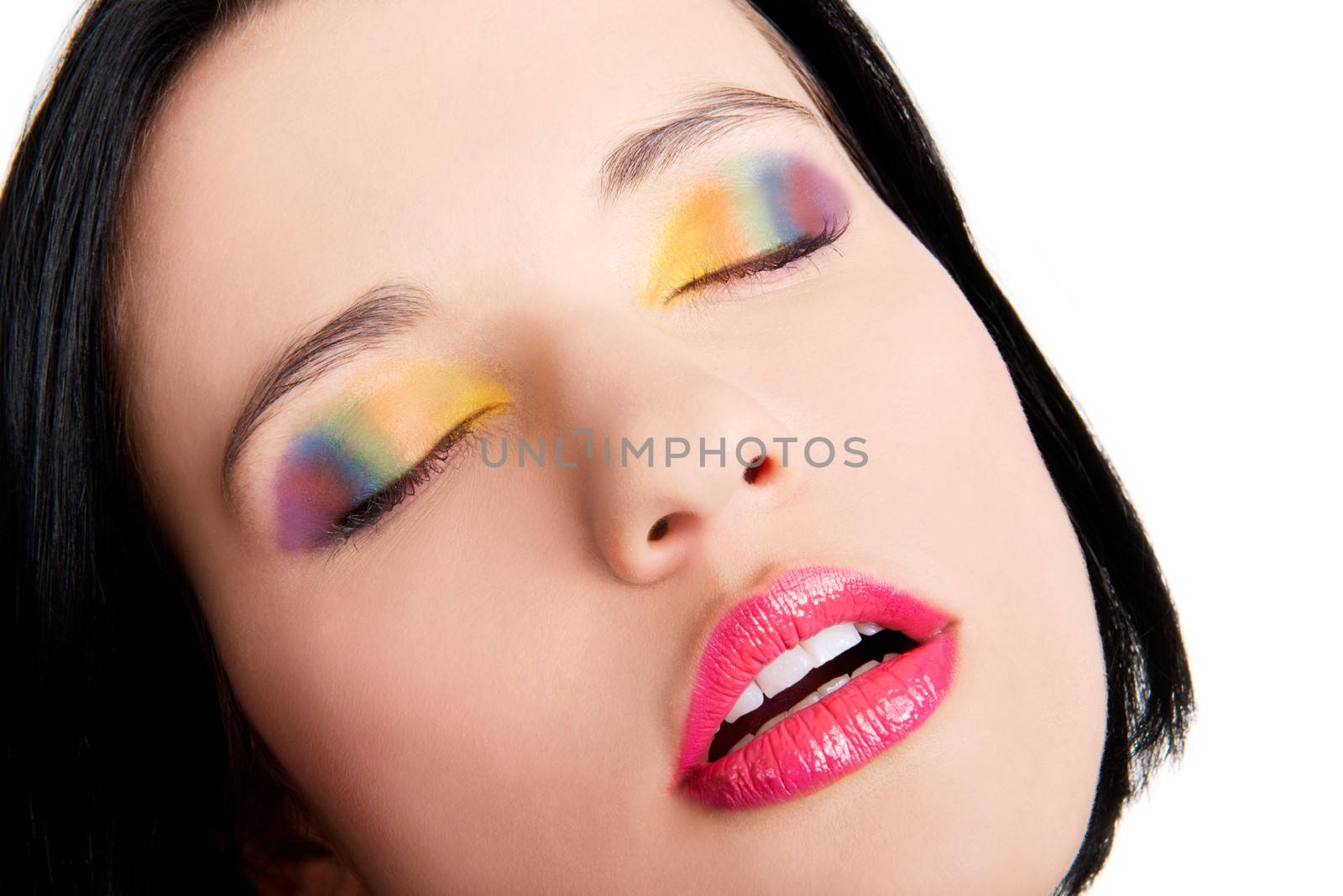 Beautiful woman with rainbow eye make up, isolated on white