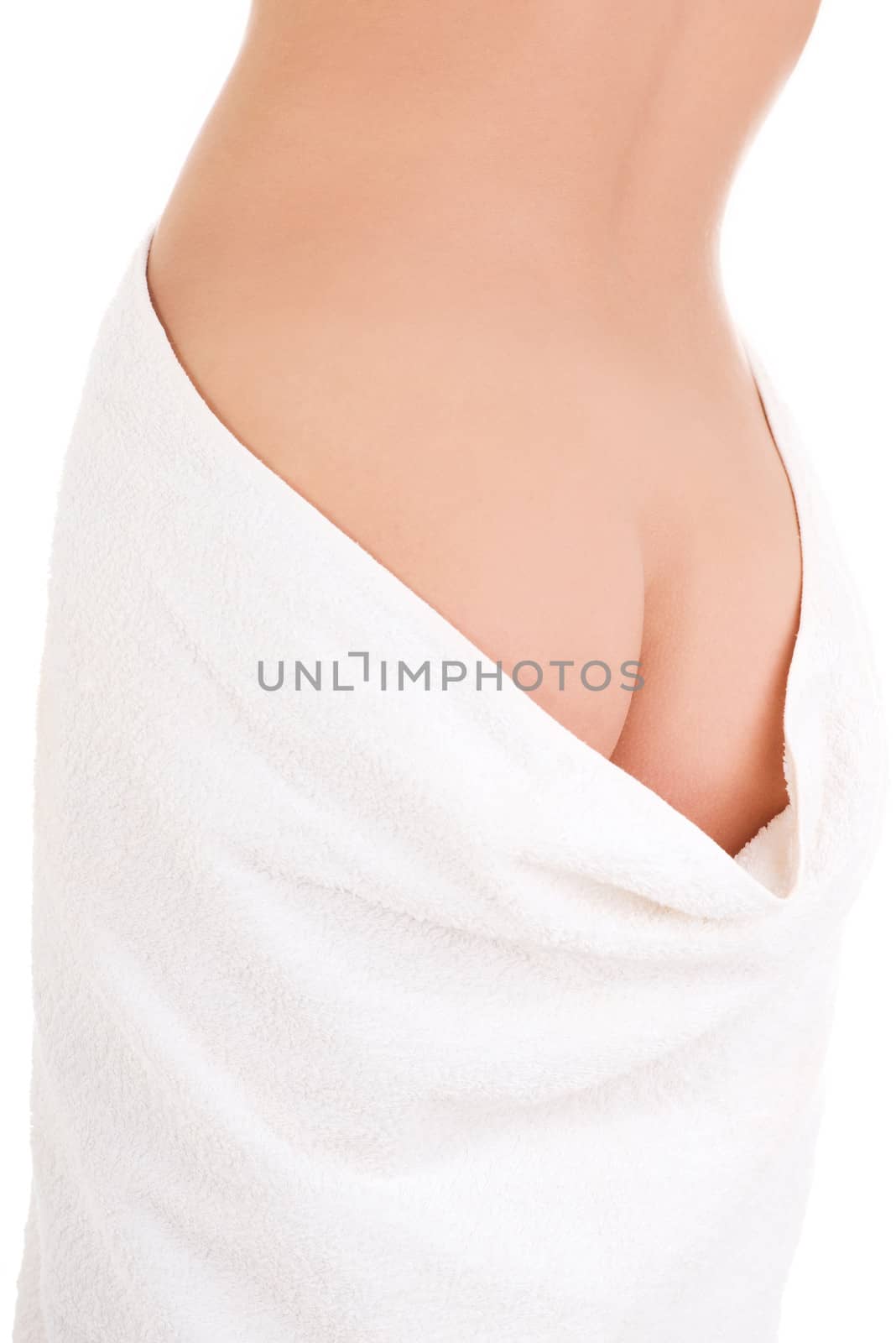 Rear view of slim tanned woman's body in towel.