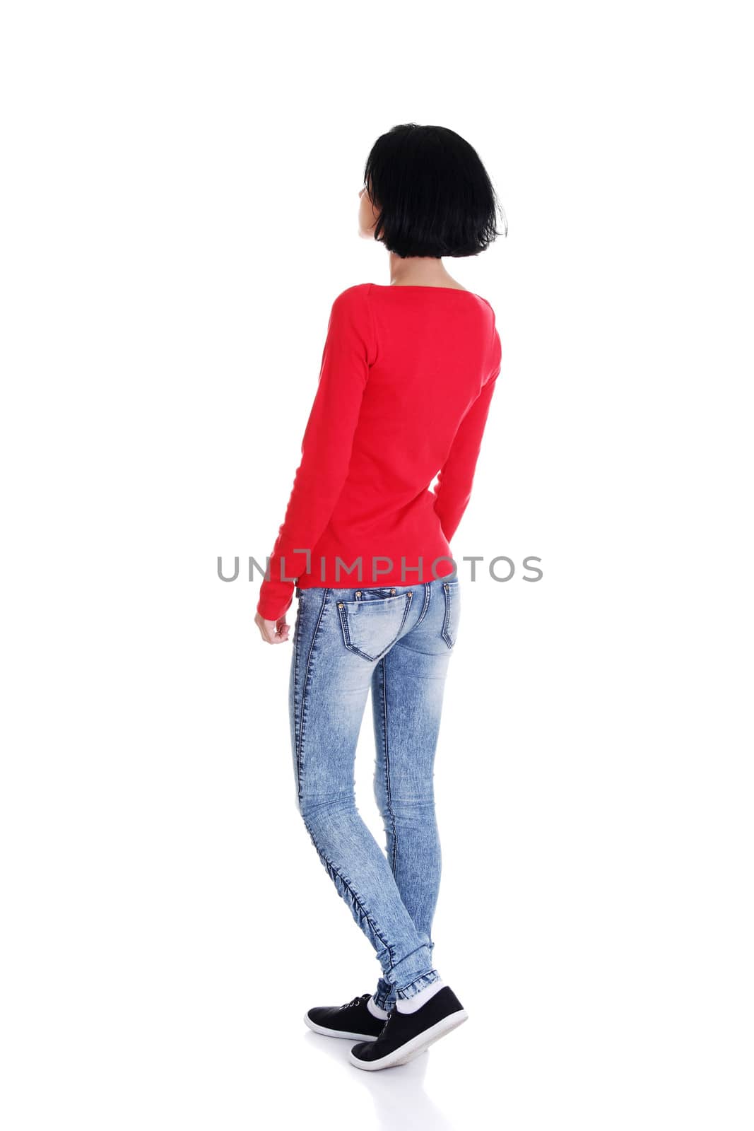 Young casual woman from behind looking up, isolated on white