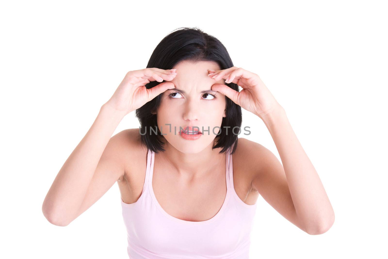 Beautiful shocked woman checking her first wrinkles on forehead