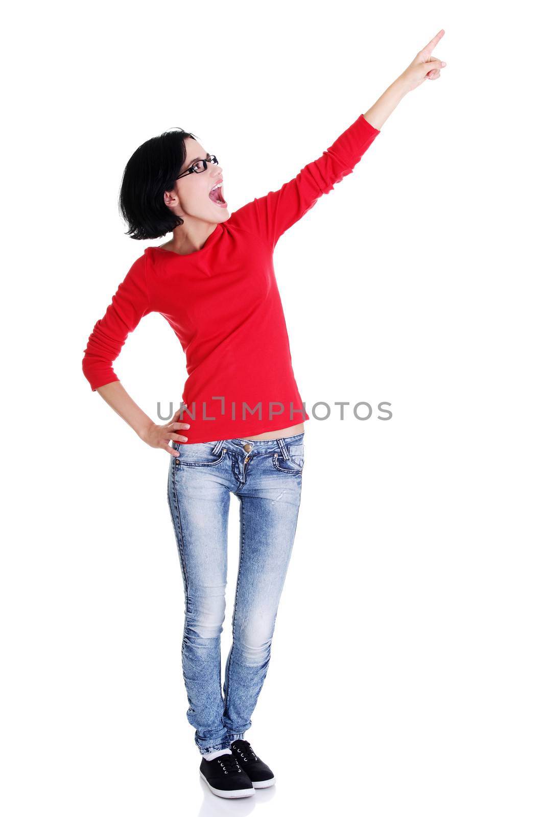 Happy , excited young woman pointing on copy space, isolated on white