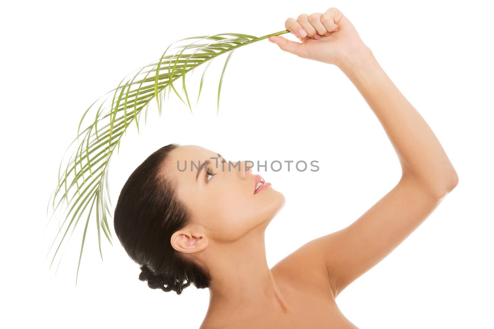 Portrait of young beautiful woman with green leaf