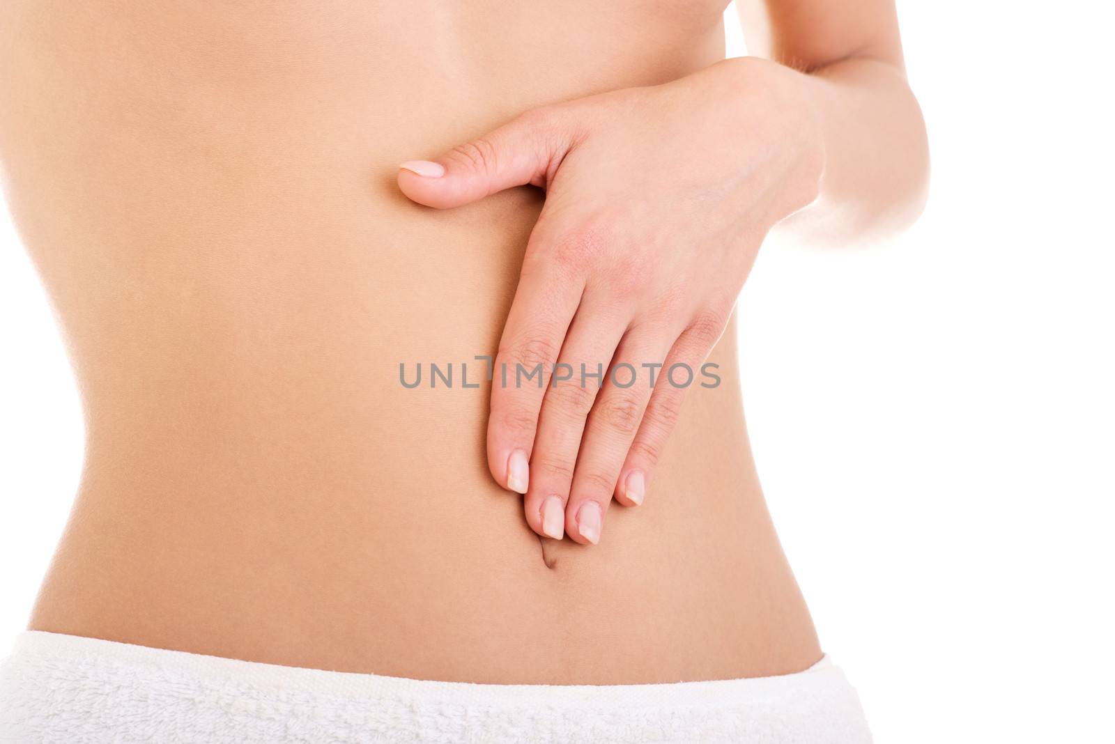 Hand on fit slim woman belly, isolated on white background