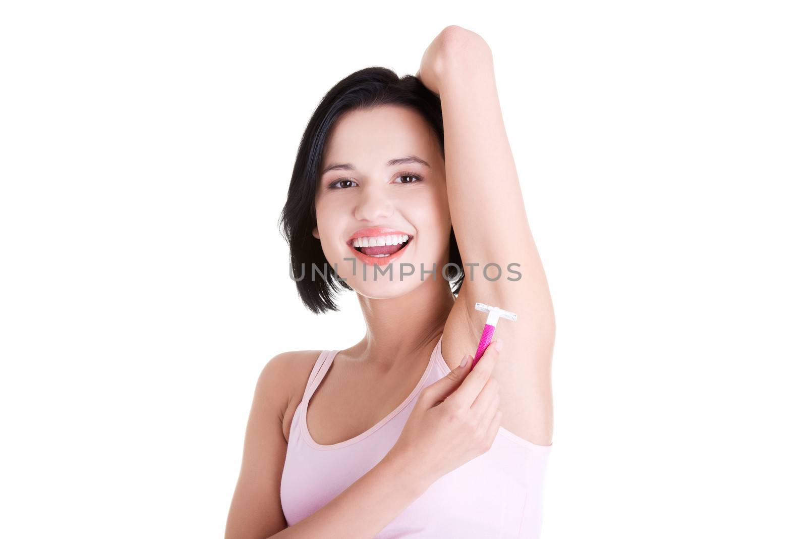 Beautiful smiling young woman shaving her armpit