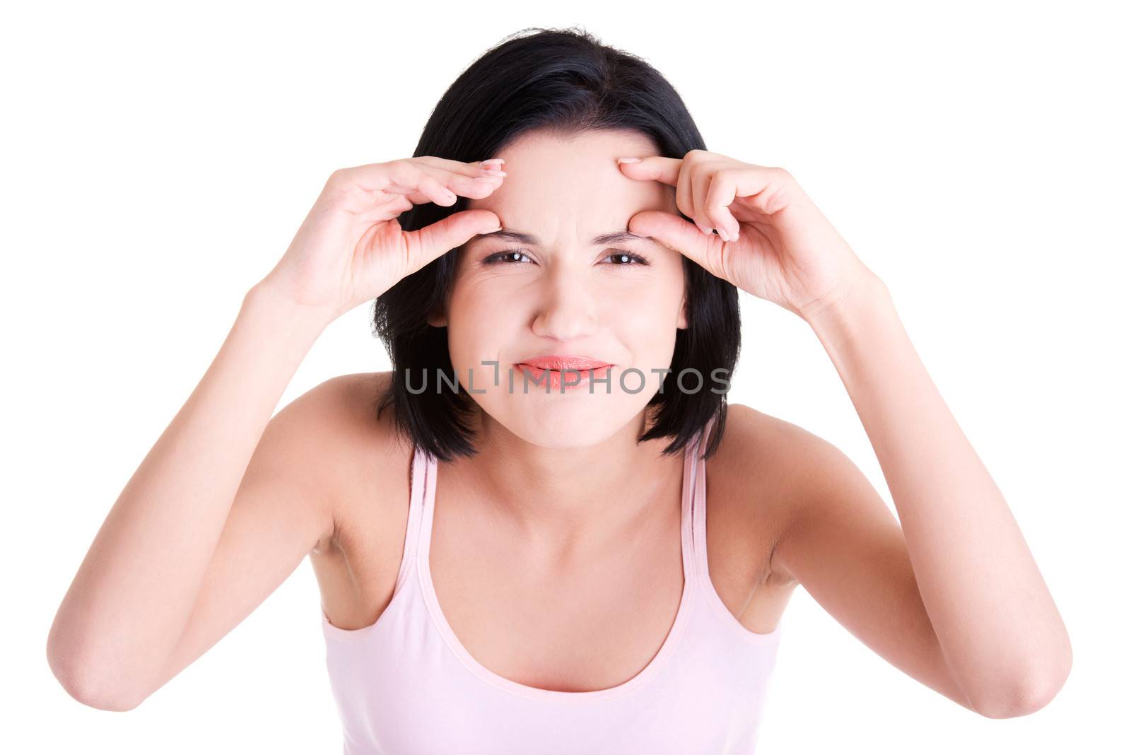 Beautiful shocked woman checking her first wrinkles on forehead