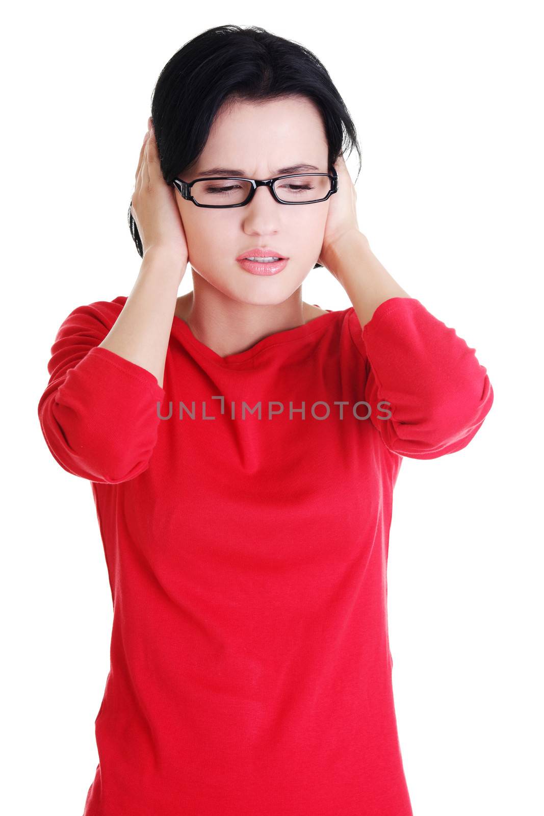 Closeup of frustrated young woman holding her ears, isolated on white