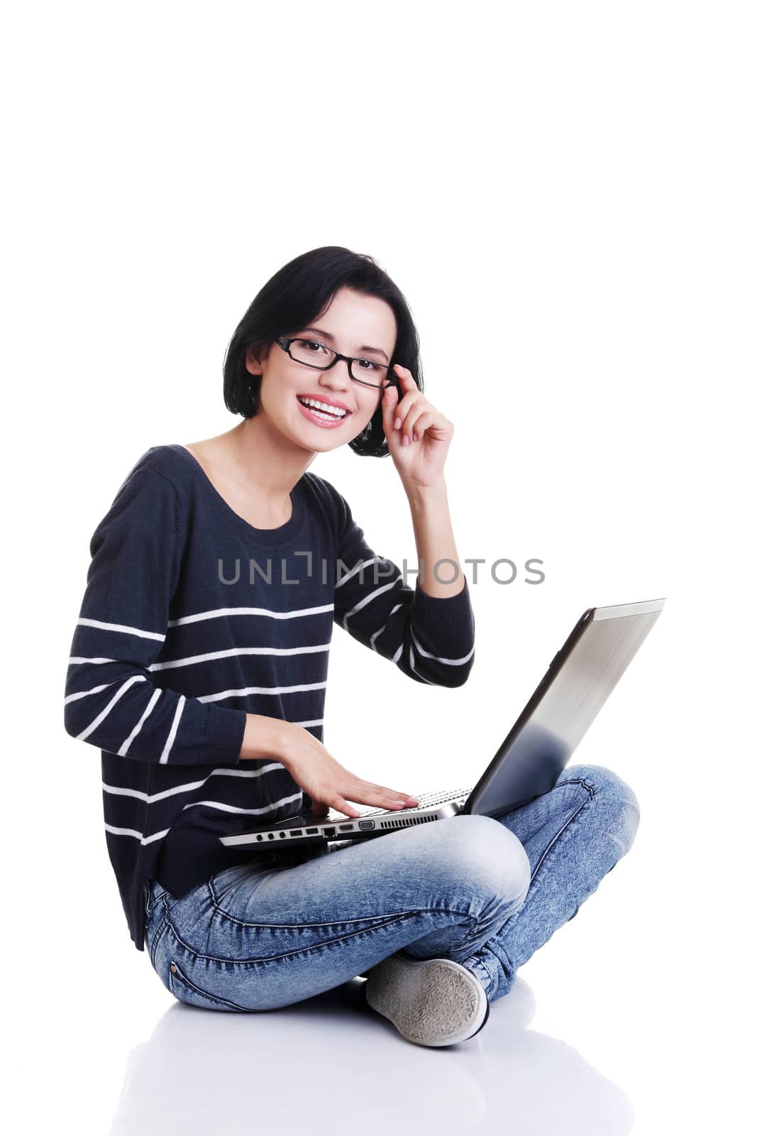Happy young woman using her laptop, isolated on white.