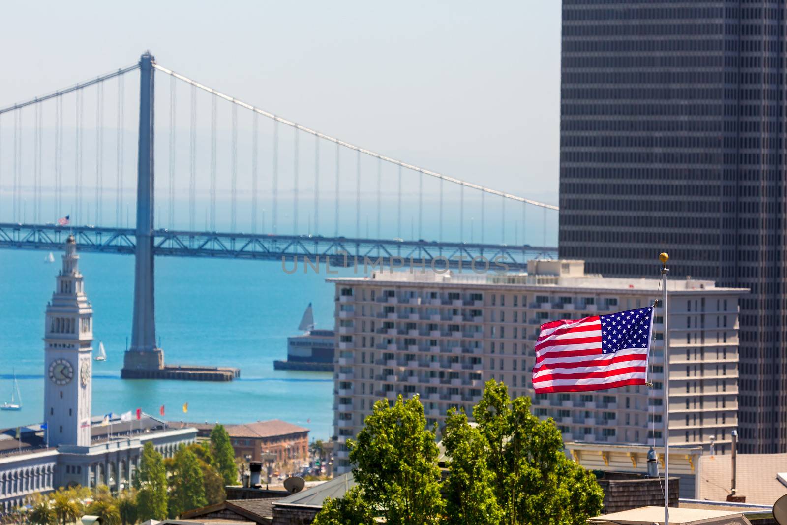 San Francisco USA American Flag Bay Bridge and Embarcadero Clock Tower from Telegraph Hill