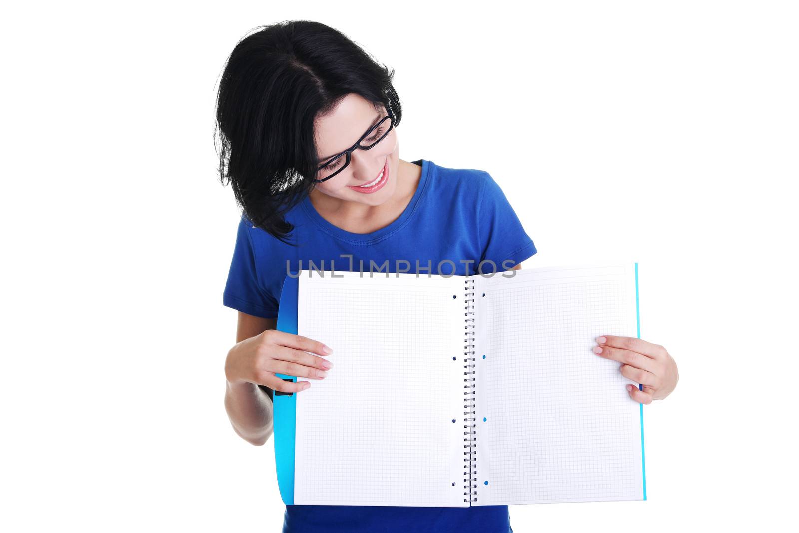 Studying happy young woman showing blank pages of her notebook for school.