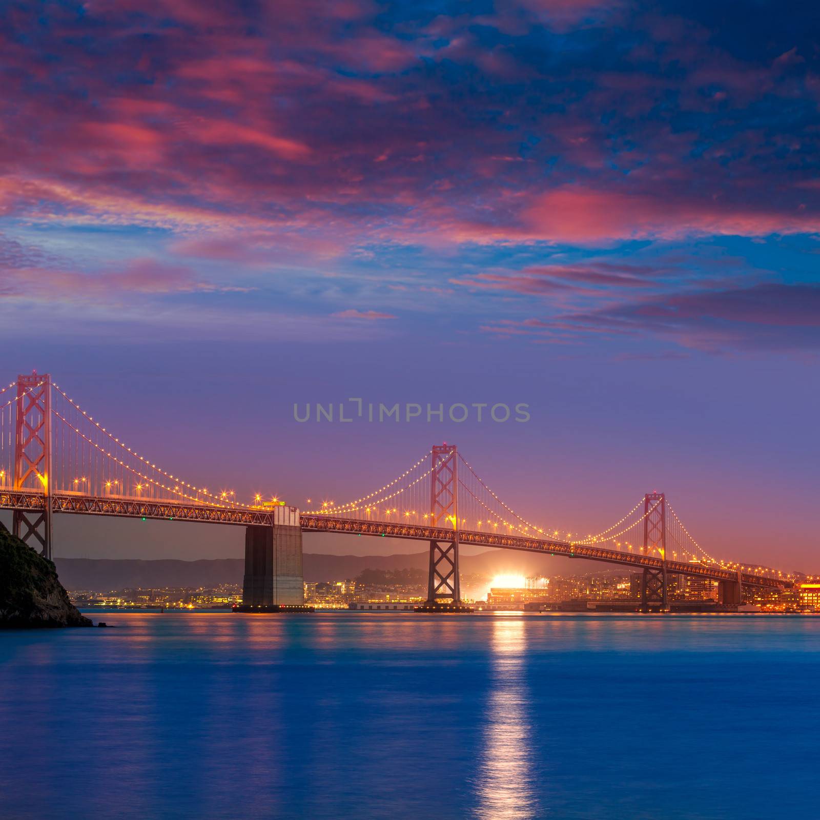 Bay Bridge at sunset in San Francisco California by lunamarina