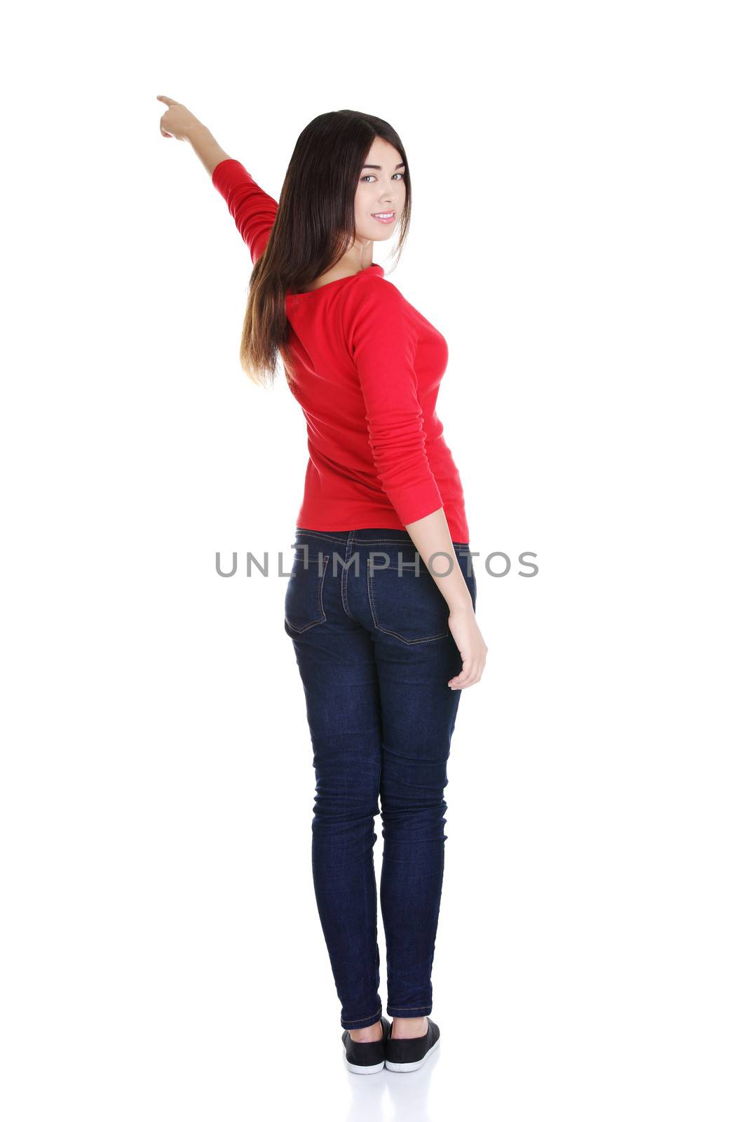 Happy young woman pointing on copy space by BDS