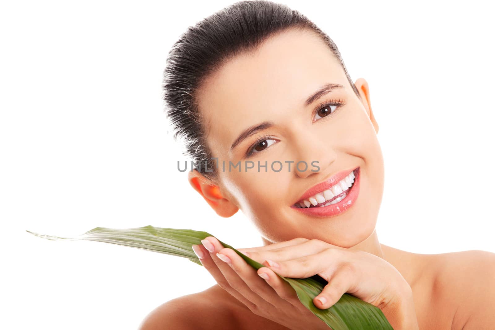 Portrait of young beautiful smiling woman with green leaf . Spa treatment concept